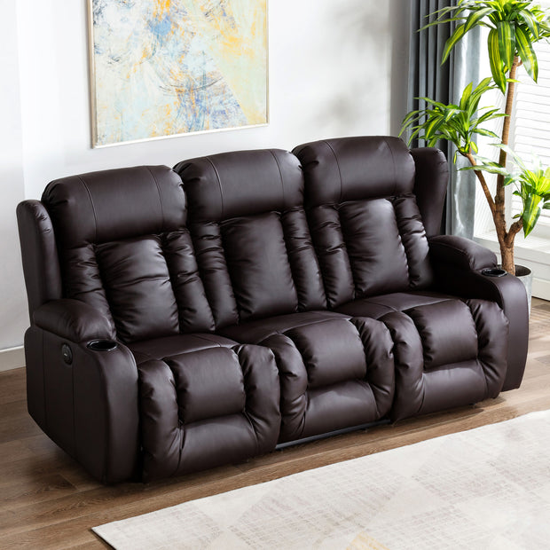 Dark brown leather three-seater recliner sofa, featuring cushioned backrests with detailed vertical stitching and cupholders, set in a living room with wooden flooring and a grey rug. An abstract painting hangs above the sofa.