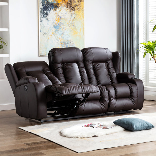 Dark brown leather three-seater recliner sofa with one seat fully reclined, featuring cushioned backrests, cupholders, and vertical stitching, in a living room with wooden flooring and abstract wall art.