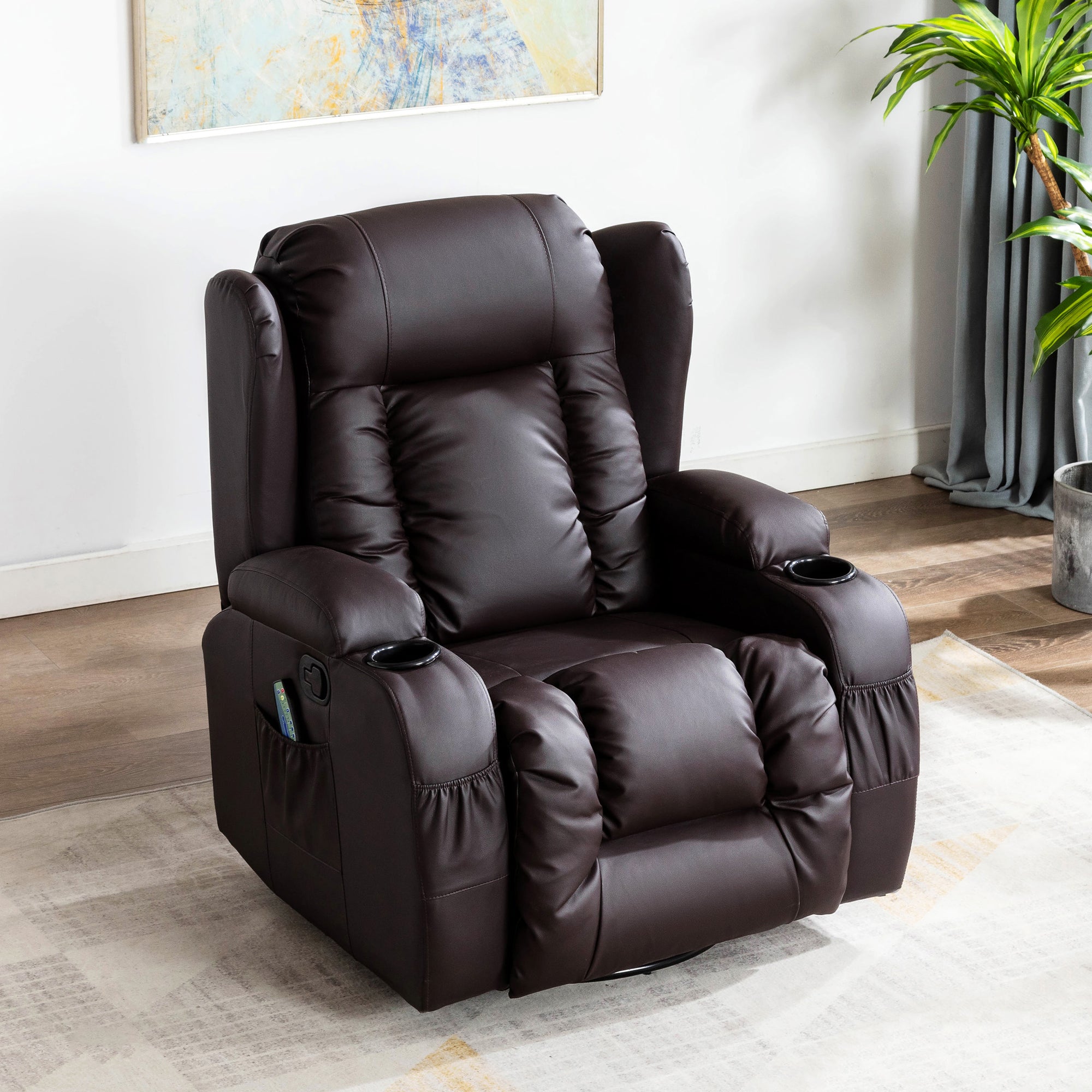 Brown leather electric recliner with a cushioned backrest featuring vertical stitching, padded armrests, cup holders, and front and side pockets, set in a living room with an abstract painting hung on the wall above the chair. 