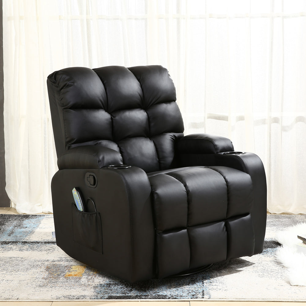 Black leather manual recliner with tufted backrest, cup holders, and a side pocket, set in a living room with light curtains and a patterned rug. A book and a magazine rest on the floor nearby.