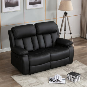 Black leather two-seater manual recliner sofa with padded armrests and cushioned backrests featuring vertical stitching, placed on a light-coloured rug in a living room. Two photos hang above the sofa.