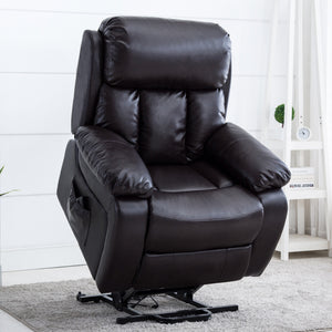 Black leather rise recliner chair on a grey rug in a bright living space, featuring a small white shelf with books and a plant in the background.