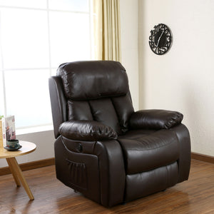 Dark brown leather electric recliner with padded armrests and a cushioned backrest featuring vertical stitching, positioned in a living room with wood flooring and a side pocket. The room is decorated with a round side table, books, and wall art.