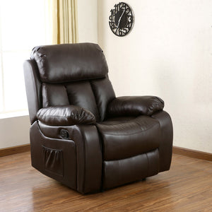Dark brown leather manual recliner with padded armrests and a cushioned backrest featuring vertical stitching, positioned in a living room with wood flooring and a side pocket. The room is decorated with a clock.