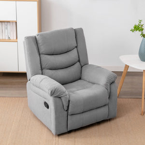 Grey fabric manual recliner chair in a cosy living room with light wooden furniture, a white side table, and a small green plant in a vase.