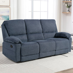 Blue fabric manual reclining three-seater sofa with padded armrests, positioned on a light-coloured rug in a living room near large windows.