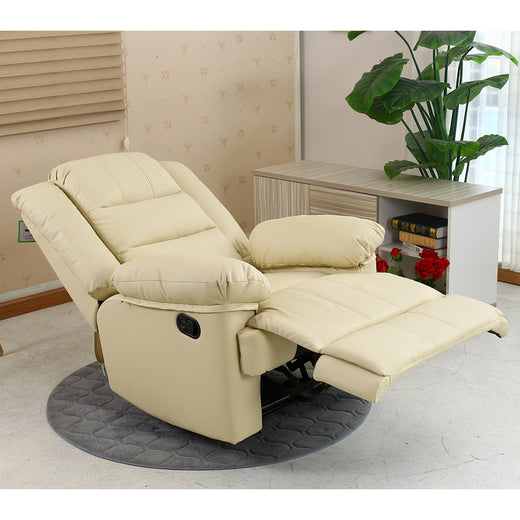 A cream-coloured manual recliner chair in a fully reclined position, placed on a grey circular rug, next to a side table with books and plants in a cosy room.