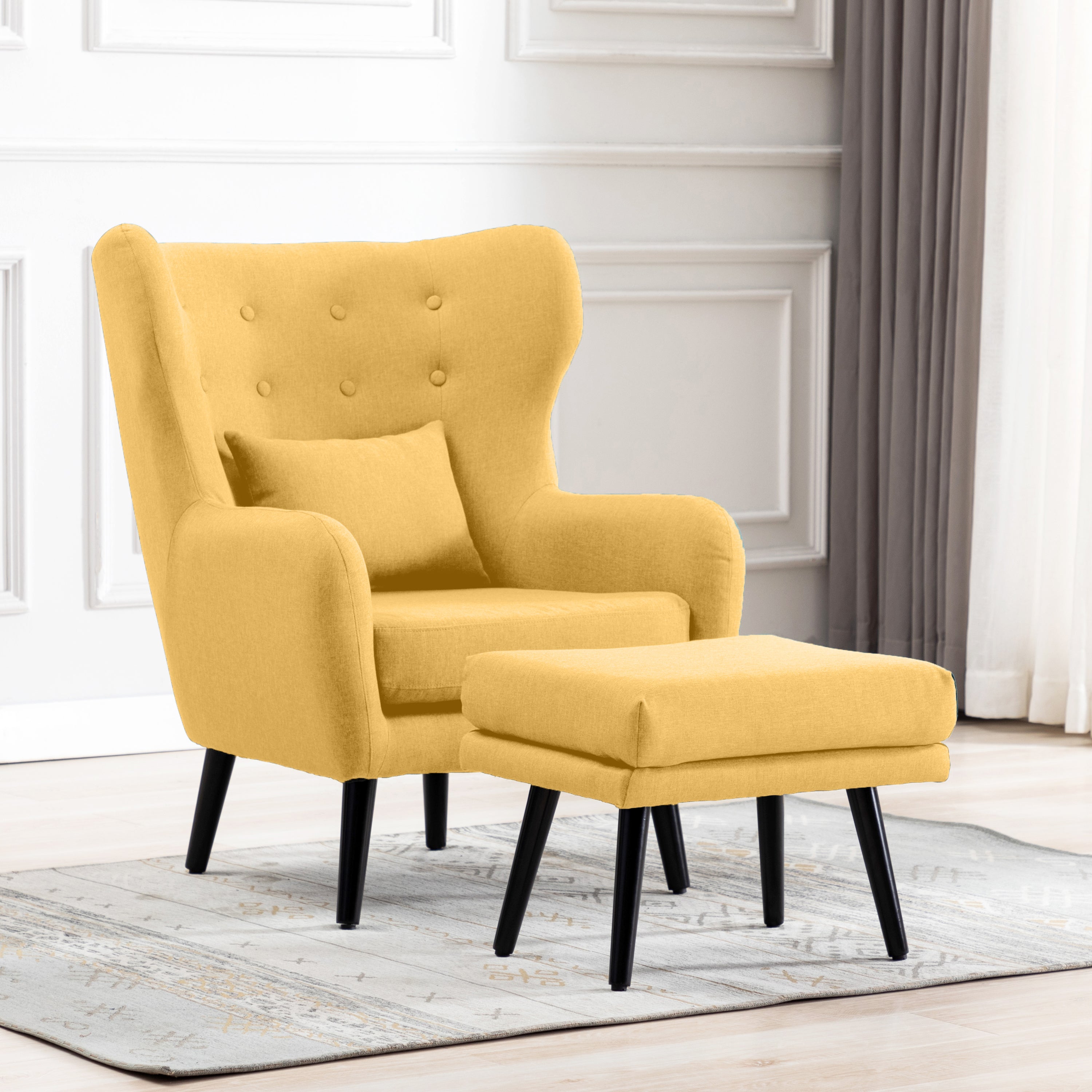 Yellow linen accent wingback chair with tufted buttons, paired with a matching footstool, set on a grey patterned rug against a white panelled wall.