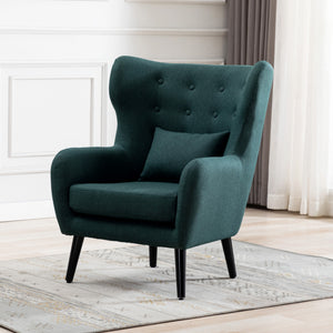 Green linen accent wingback chair with tufted buttons, set on a grey patterned rug against a white panelled wall.
