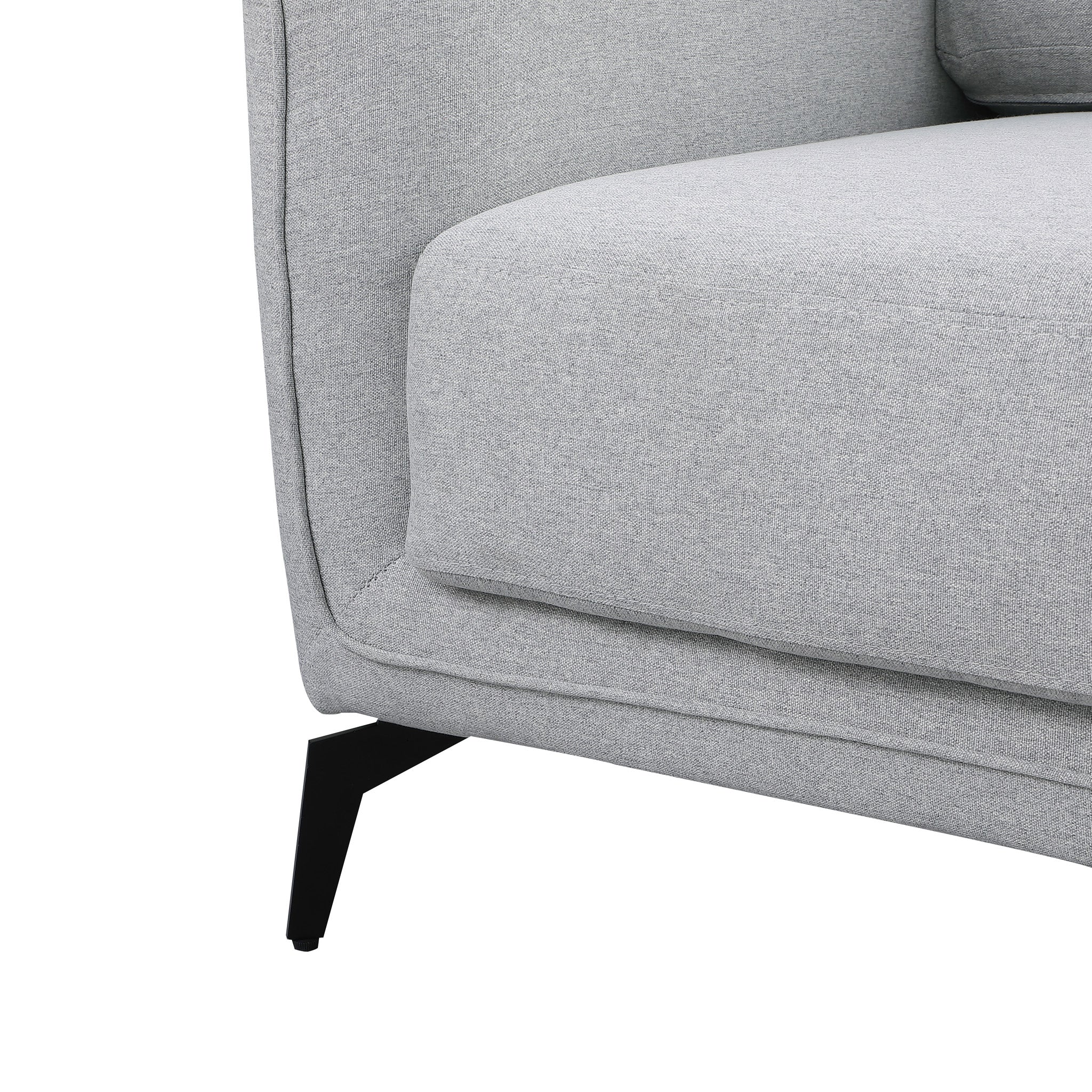 Close-up of a grey upholstered sofa with black metal legs.