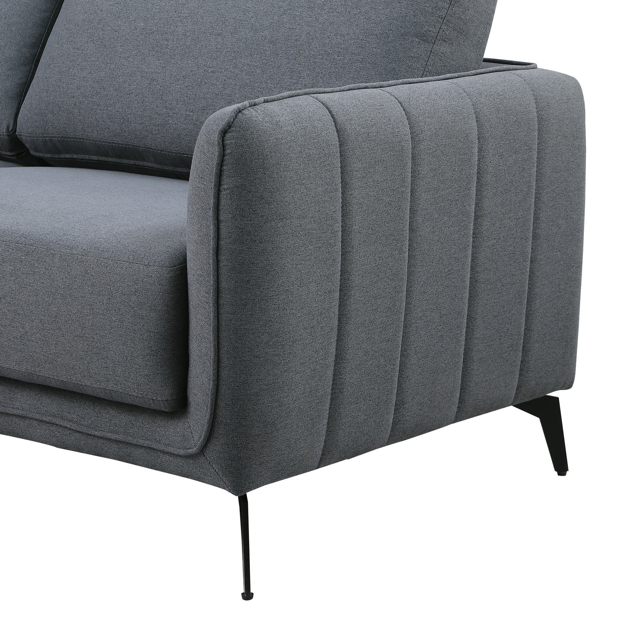 Close-up of a dark grey fabric sofa with black legs set against a white backdrop. The armrest features vertical stitching details.